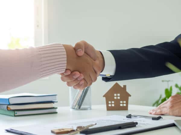 Sales-agents-and-customers-shaking-hands-after-signing-a-contract-to-buy-a-new-house-or-apartment-mo